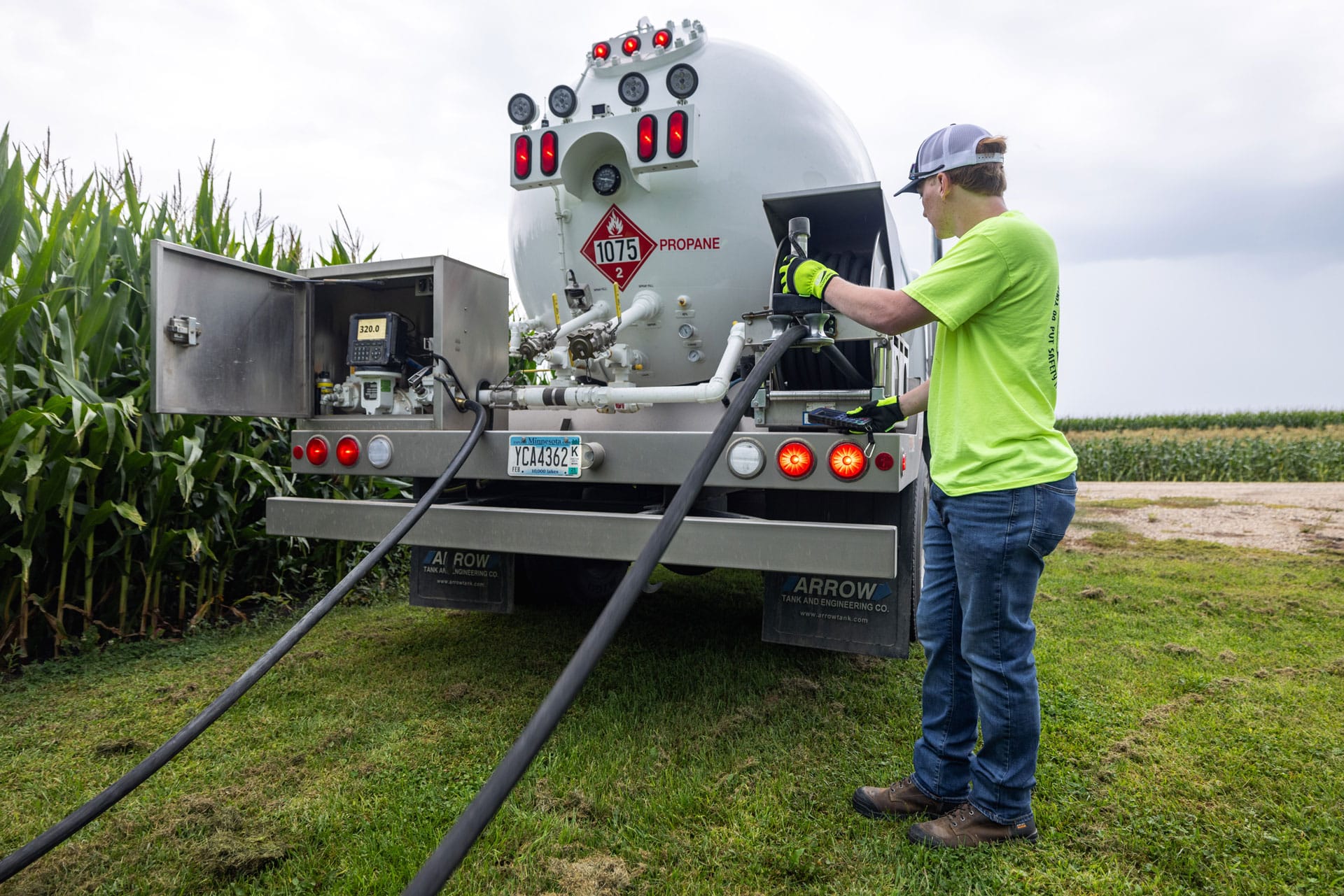 central united coop energy propane man with propane truck filling a propane tank next to corn field central united coop energy propane man with propane truck filling a propane tank next to corn field