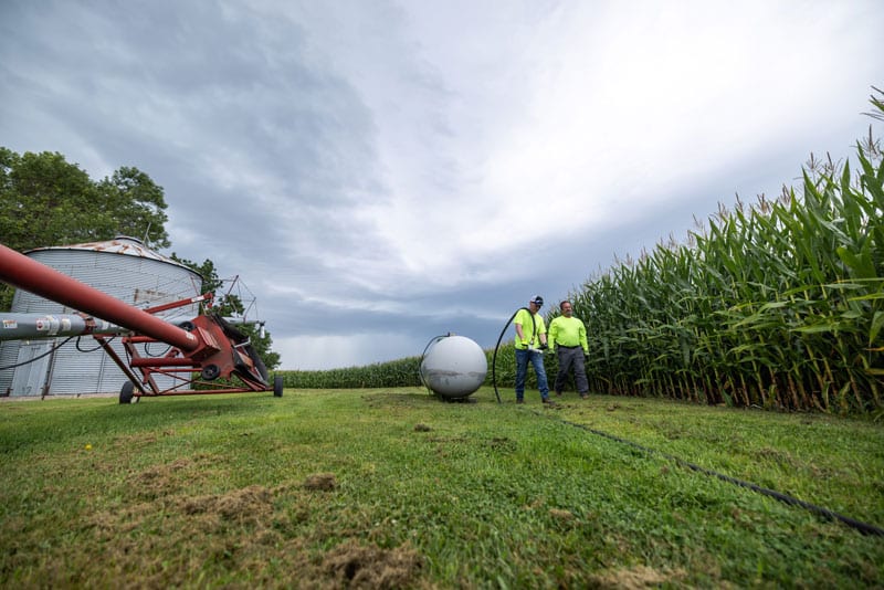 central united coop energy propane two men filling a propane tank on a farm near a corn field central united coop energy propane two men filling a propane tank on a farm near a corn field